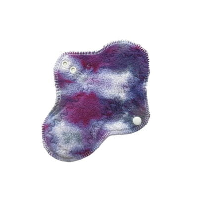 A washable cloth menstrual pad with purple galaxy hand-dyed organic cotton sherpa top and organic merino wool backing.