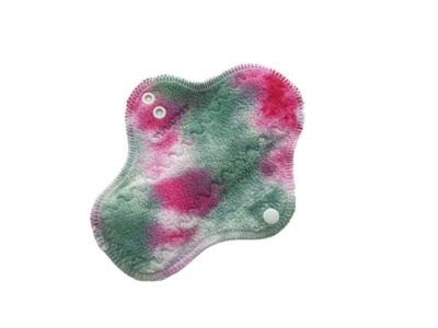 A washable cloth pad with pink and green hand-dyed top fabric and organic wool backing