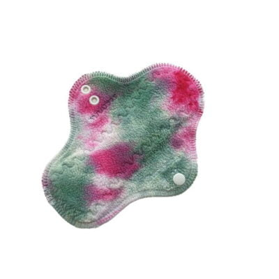 A washable cloth pad with pink and green hand-dyed top fabric and organic wool backing