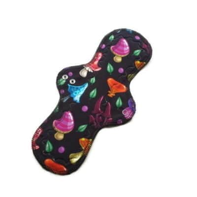 Pictured is a Roundatious shaped reusable cloth menstrual pad. It has brigt colourful mushroom organic cotton jersey print.